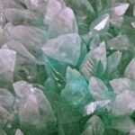 Close-up of shimmering aquamarine quartz crystals showcasing detail and translucency.